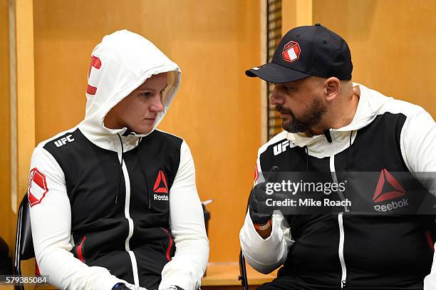 Valentina Shevchenko of Kyrgyzstan interacts with her coach backstage during the UFC Fight Night event at the United Center on July 23, 2016 in...