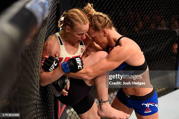 Holly Holm controls the body of Valentina Shevchenko of Kyrgyzstan in their women's bantamweight bout during the UFC Fight Night event at the United...