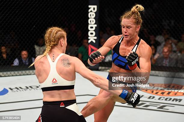 Holly Holm lands a leg check against Valentina Shevchenko of Kyrgyzstan in their women's bantamweight bout during the UFC Fight Night event at the...