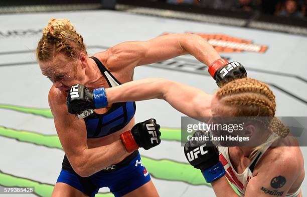 Valentina Shevchenko of Kyrgyzstan punches Holly Holm in their women's bantamweight bout during the UFC Fight Night event at the United Center on...