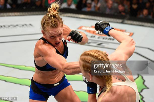 Holly Holm punches Valentina Shevchenko of Kyrgyzstan in their women's bantamweight bout during the UFC Fight Night event at the United Center on...