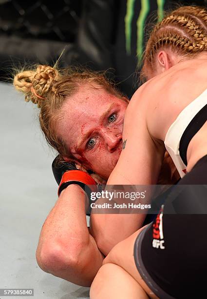 Holly Holm looks to escape the body control of Valentina Shevchenko of Kyrgyzstan in their women's bantamweight bout during the UFC Fight Night event...
