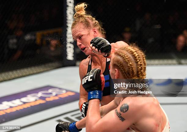 Valentina Shevchenko of Kyrgyzstan punches Holly Holm in their women's bantamweight bout during the UFC Fight Night event at the United Center on...