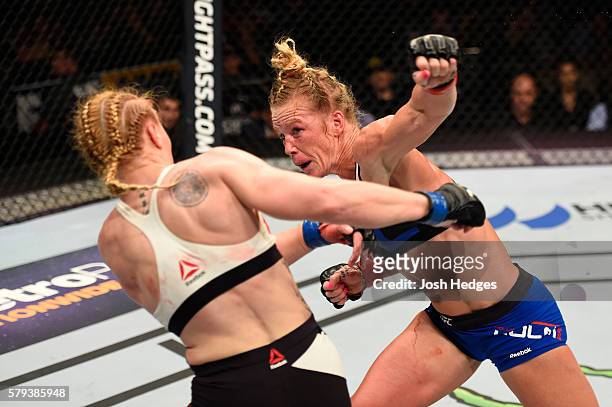 Holly Holm punches Valentina Shevchenko of Kyrgyzstan in their women's bantamweight bout during the UFC Fight Night event at the United Center on...
