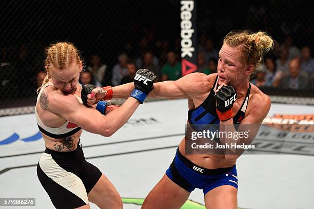 Holly Holm punches Valentina Shevchenko of Kyrgyzstan in their women's bantamweight bout during the UFC Fight Night event at the United Center on...