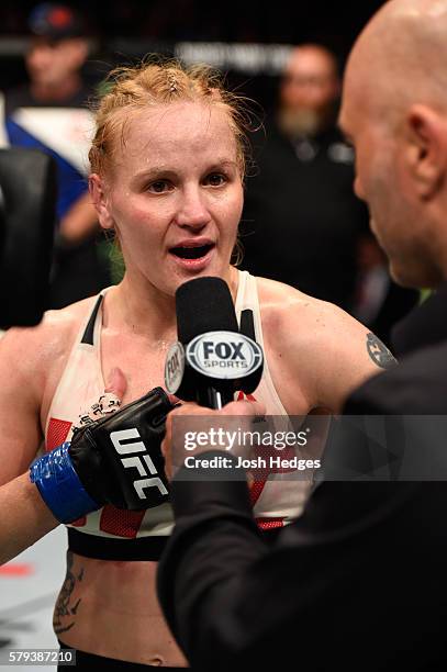 Valentina Shevchenko of Kyrgyzstan speaks with Joe Rogan after defeating Holly Holm in their women's bantamweight bout during the UFC Fight Night...