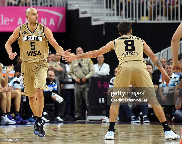 Manu Ginobili of Argentina high-fives teammate Nicolas Laprovittola after Ginobili scored against the United States during a USA Basketball showcase...