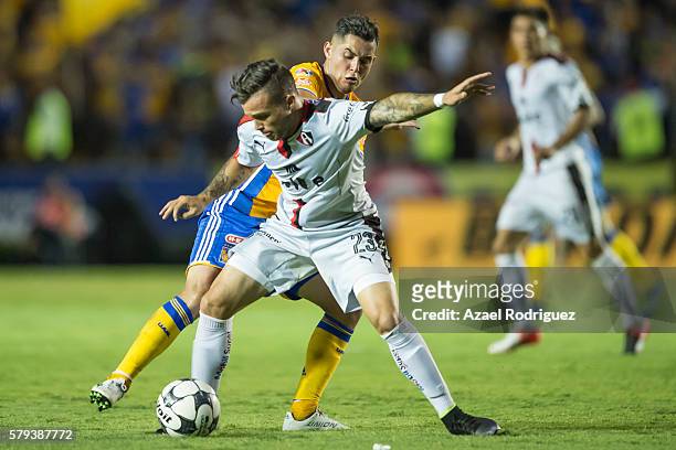Israel Jimenez of Tigres fights for the ball with Christian Tabo of Atlas during the 2nd round match between Tigres UANL and Atlas as part of the...