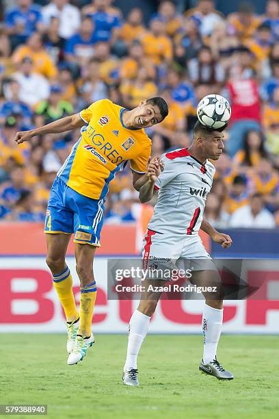 Hugo Ayala of Tigres heads the ball with Jefferson Duque of Atlas during the 2nd round match between Tigres UANL and Atlas as part of the Torneo...