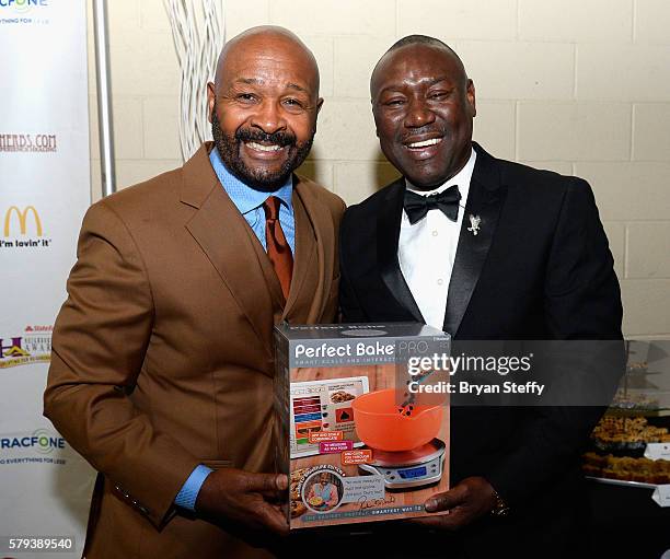 Neighborhood Awards Executive Producer Rushion McDonald and attorney Benjamin Crump pose backstage during the 2016 Neighborhood Awards hosted by...