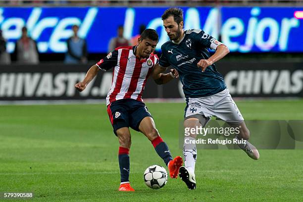 Jose Vazquez of Chivas fights for the ball with Jose Basanta of Monterrey during the 2nd round match between Chivas and Monterrey as part of the...