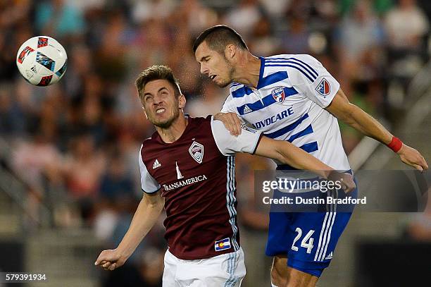 Kevin Doyle of Colorado Rapids and Matt Hedges of FC Dallas jump to control the ball during a game at Dick's Sporting Goods Park on July 23, 2016 in...