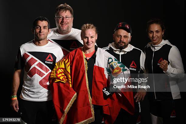 Valentina Shevchenko of Kyrgyzstan poses for a post fight portrait with her team after defeating Holly Holm by unanimous decision during the UFC...