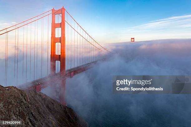 golden gate bridge with low fog, san francisco - golden gate bridge city fog stock pictures, royalty-free photos & images
