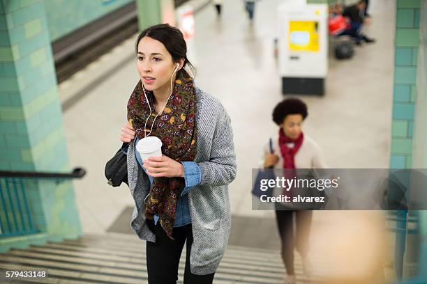 young woman leaving subway station - disembarking train stock pictures, royalty-free photos & images