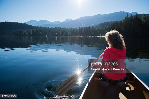 senior woman enjoying an active retirement - seniors canoeing stock pictures, royalty-free photos & images