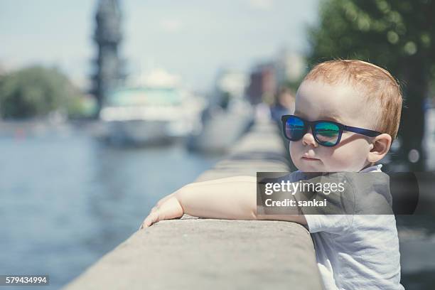 porträt eines niedlichen rothaarigen jungen in sonnenbrille - baby in sunglass stock-fotos und bilder