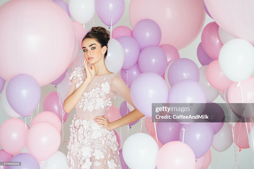 Beautiful girl at the studio with balloons