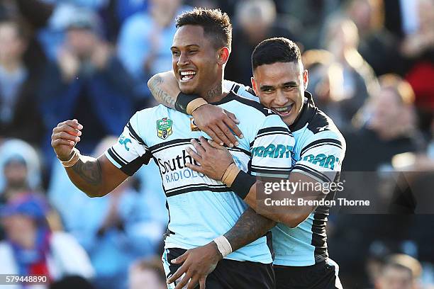 Ben Barba of the Sharks celebrates with team mate Valentine Holmes after scoring a try during the round 20 NRL match between the Cronulla Sharks and...