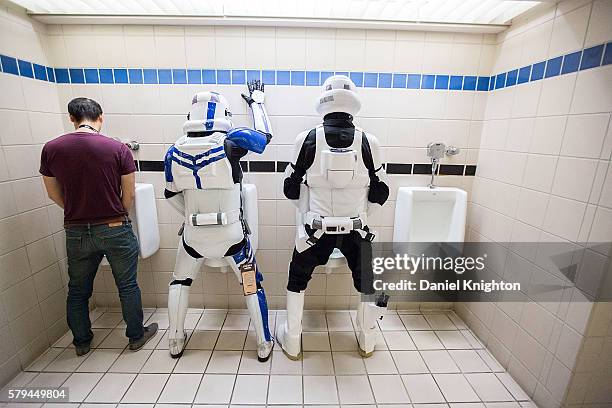 Pair of fans dressed as Star Wars stormtroopers pose for a photo in the restroom at Comic-Con International - Day 3 on July 22, 2016 in San Diego,...