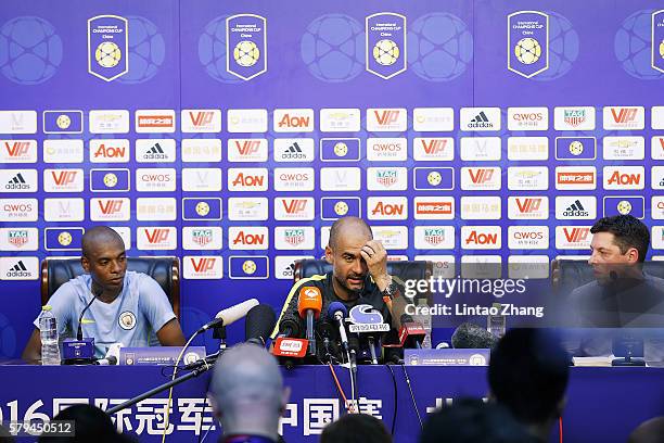 Manchester City's manager Pep Guardiola with Manchester's Brazilian midfielder Fernandinho Roza attends a press conference for 2016 International...