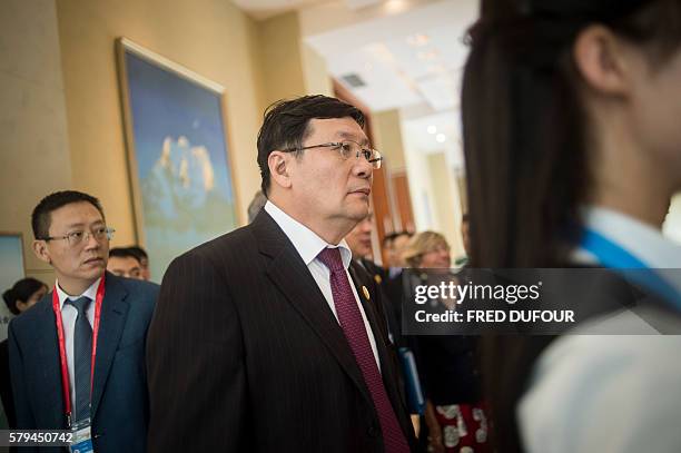 China's Finance Minister Lou Jiwei leaves after attending a session at the G20 finance ministers meeting in Chengdu, in China's Sichuan province on...