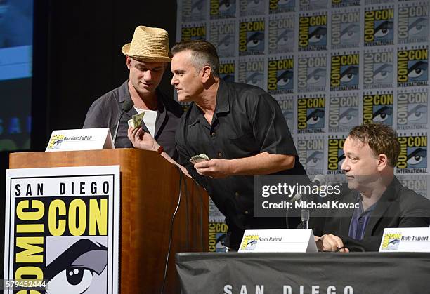 Moderator Dominic Patten, actor Bruce Campbell and director Sam Raimi speaks on stage during the "Ash vs Evil Dead" panel during Comic-Con...