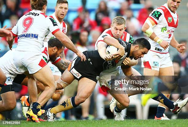 Dene Halatau of the Tigers is tackled during the round 20 NRL match between the St George Illawarra Dragons and the Wests Tigers at ANZ Stadium on...