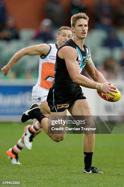 Hamish Hartlett of the Power runs with the ball during the round 18 AFL match between the Port Adelaide Power and the Greater Western Sydney Giants...