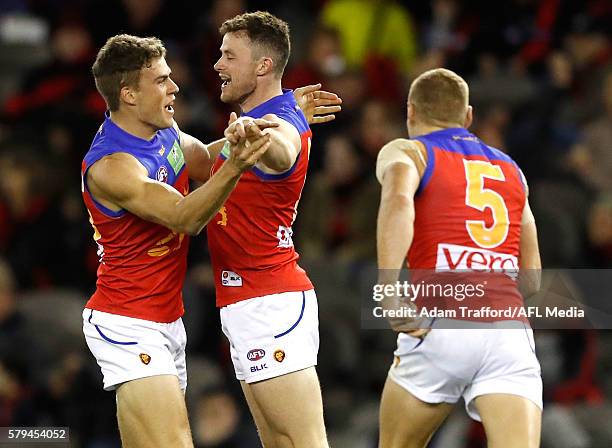 Pearce Hanley of the Lions celebrates a goal with Tom Cutler of the Lions during the 2016 AFL Round 18 match between the Essendon Bombers and the...