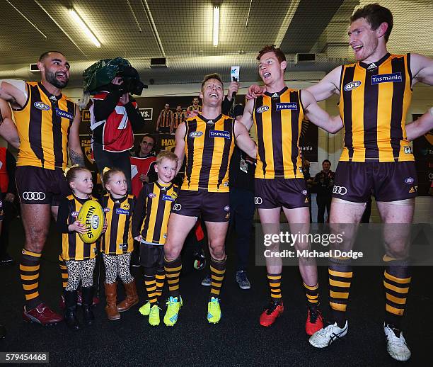 Sam Mitchell of the Hawks sing the club song with his kids after winning his 300th match during the round 18 AFL match between the Hawthorn Hawks and...