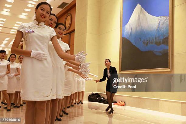 Hostesses pose for photos during a break from the G20 Finance Ministers and Central Bank Governors meeting on July 24, 2016 in Chengdu, China....