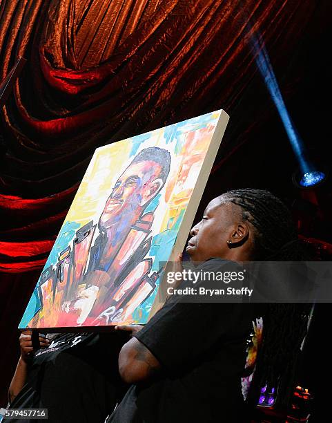 Painters Rachel Crouch and Rebecca Crouch display their artwork during the 2016 Neighborhood Awards hosted by Steve Harvey at the Mandalay Bay Events...