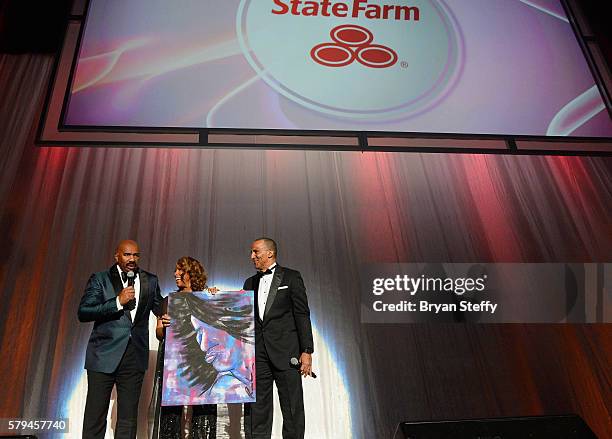 Host Steve Harvey, Marjorie Harvey and State Farm Mutual Automobile Insurance Company Executive VP and Chief Administrative Officer Duane Farrington...