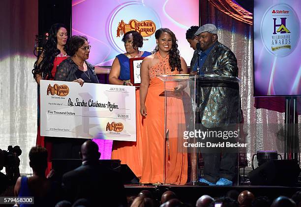 Winner of "Best School Teacher" Dr. Shandra Claiborne-Payton and actor/comedian Lavell Crawford pose with the award check from Cracker Barrel during...
