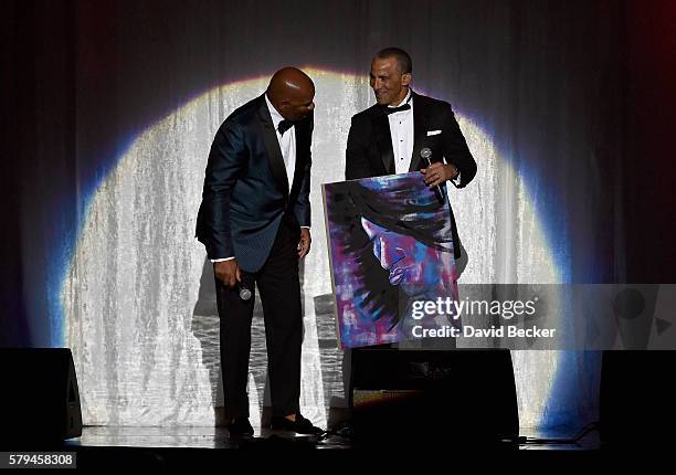 Host Steve Harvey and State Farm Mutual Automobile Insurance Company Executive VP and Chief Administrative Officer Duane Farrington speak during the...