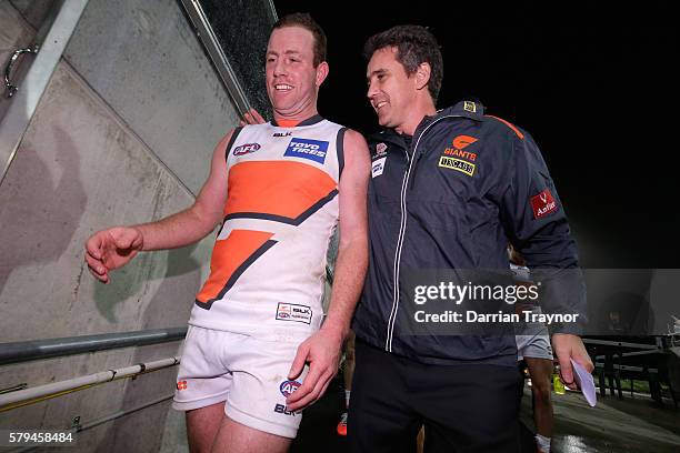 Steve Johnson of the Giants is congratulated by his coach Leon Cameron during the round 18 AFL match between the Port Adelaide Power and the Greater...