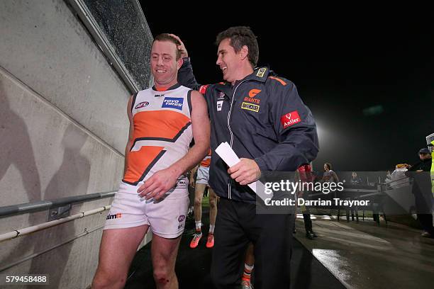 Steve Johnson of the Giants is congratulated by his coach Leon Cameron during the round 18 AFL match between the Port Adelaide Power and the Greater...