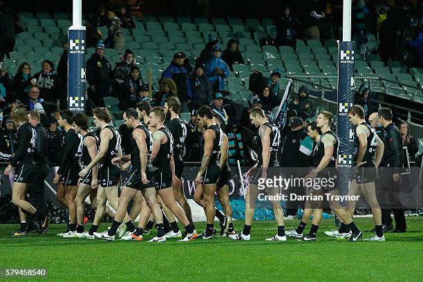 Dejected Port Adelaide players walk from the ground after the round 18 AFL match between the Port Adelaide Power and the Greater Western Sydney...
