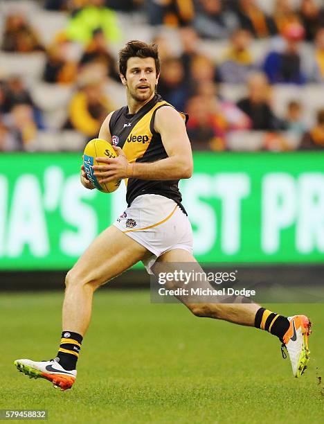 Trent Cotchin of the Tigers looks upfield during the round 18 AFL match between the Hawthorn Hawks and the Richmond Tigers at Melbourne Cricket...