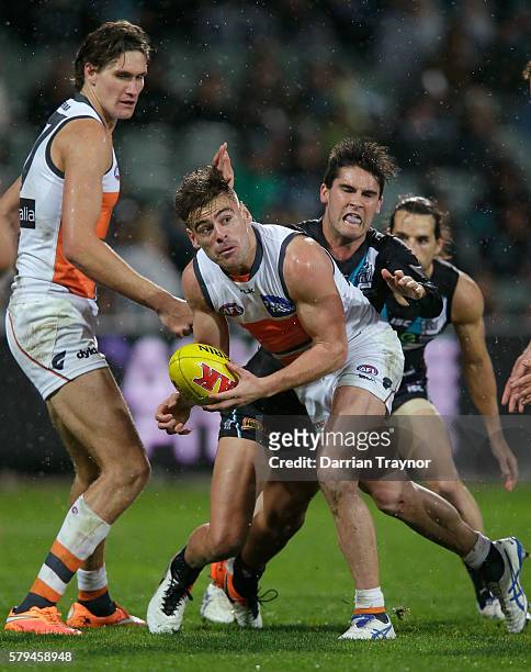 Stephen Coniglio of the Giants handballs during the round 18 AFL match between the Port Adelaide Power and the Greater Western Sydney Giants at...