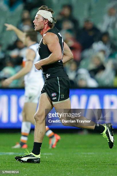Brad Ebert of the Power leaves the ground under the blood rule during the round 18 AFL match between the Port Adelaide Power and the Greater Western...