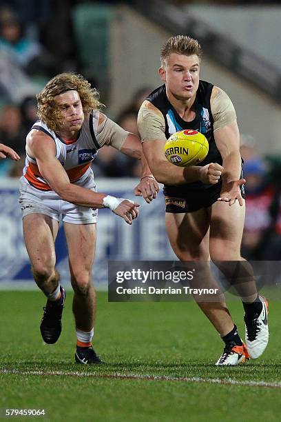 Ollie Wines of the Power handballs during the round 18 AFL match between the Port Adelaide Power and the Greater Western Sydney Giants at Adelaide...