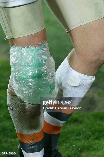 Shane Mumford of the Giants has ice wrapped around his knee during the round 18 AFL match between the Port Adelaide Power and the Greater Western...