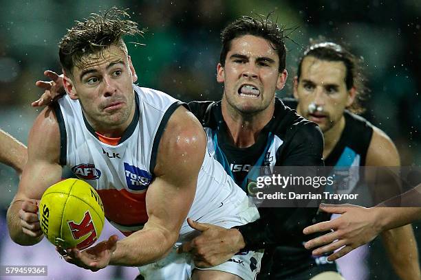 Stephen Coniglio of the Giants handballs during the round 18 AFL match between the Port Adelaide Power and the Greater Western Sydney Giants at...