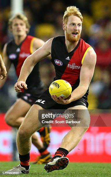 Aaron Francis of the Bombers runs with the ball during the round 18 AFL match between the Essendon Bombers and the Brisbane Lions at Etihad Stadium...