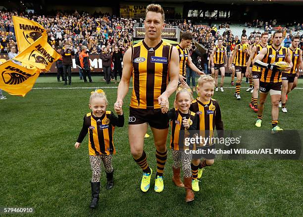 Sam Mitchell of the Hawks runs onto the field with his children for his 300th match during the 2016 AFL Round 18 match between the Hawthorn Hawks and...