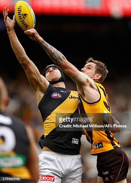 Ben Griffiths of the Tigers and Kaiden Brand of the Hawks compete for the ball during the 2016 AFL Round 18 match between the Hawthorn Hawks and the...