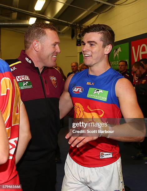 Lions head coach Justin Leppitsch and Ben Keays of the Lions celebrate after winning the round 18 AFL match between the Essendon Bombers and the...