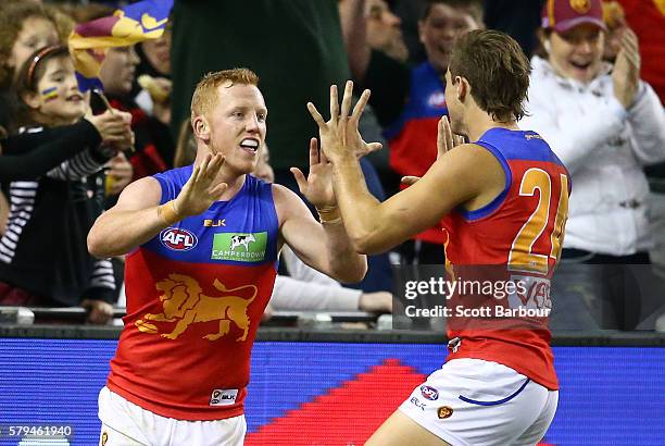 Josh Green of the Lions celebrates after kicking a goal during the round 18 AFL match between the Essendon Bombers and the Brisbane Lions at Etihad...